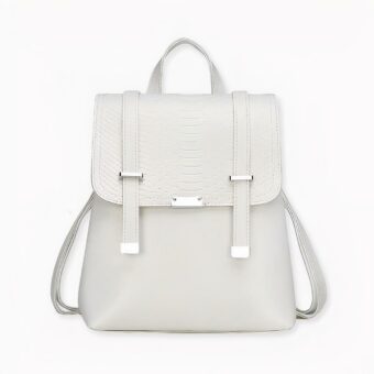 Sac à dos vintage écaillé en version blanche, sur fond gris clair.