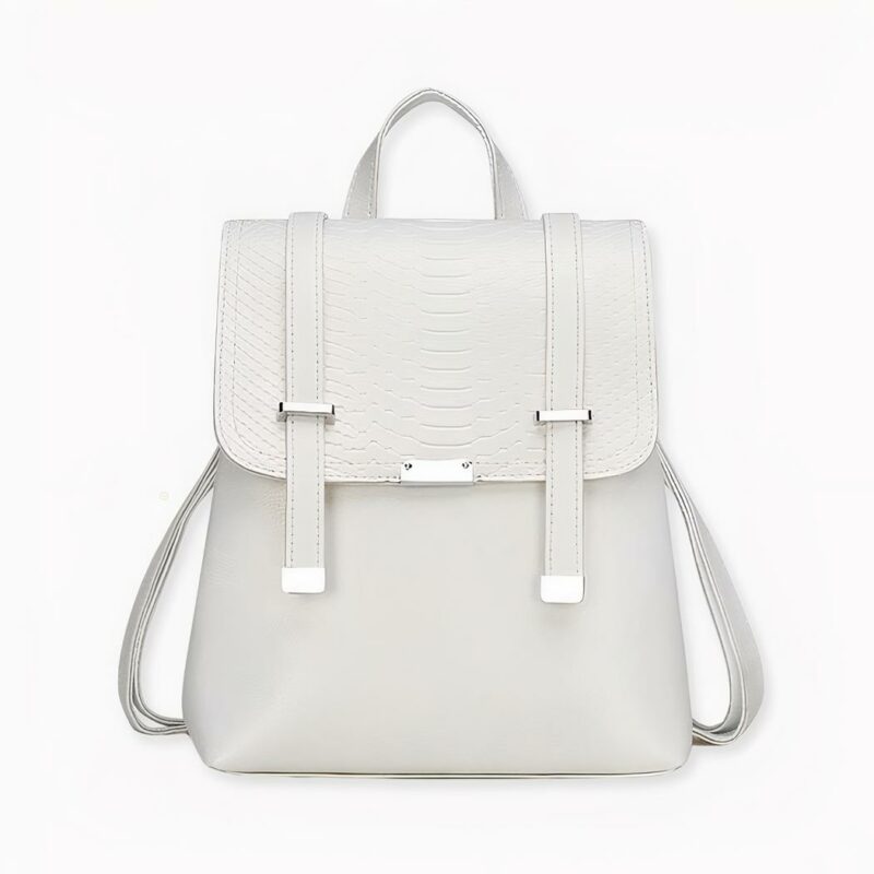 Sac à dos vintage écaillé en version blanche, sur fond gris clair.