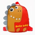 Petit sac à dos tyrannosaure pour enfant orange avec dents blancs. Bonne qualité et très à la mode.