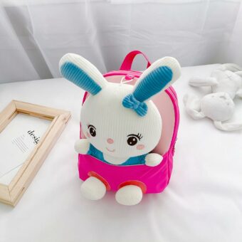 Sacs à dos d'école en peluche de lapin pour enfants rose avec un lit blanc