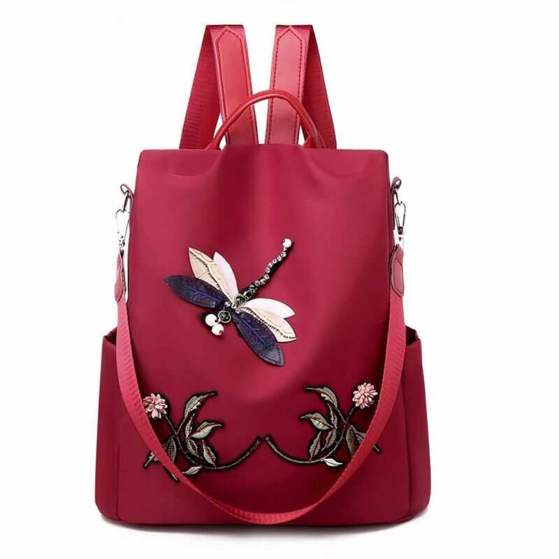 Sac à dos brodé motif fleur et papillon pour femme rouge avec un fond blanc