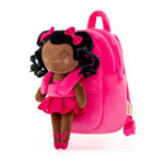 sac à dos de CP pour enfant , rose avec sur le devant une poupée en peluche d'une petite fille habillée en petite danseuse de ballet, c'est une jeune fille de couleur, elle est souriante et les yeux fermés