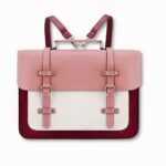 sac à dos cartable rose et blanc convertible en sac à main, sur fond gris clair