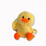 Petit sac à dos pour enfant en forme de canard jaune, sur fond gris clair