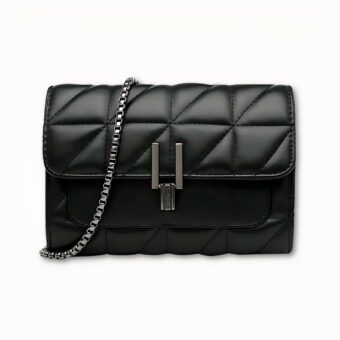 Sacoche à bandoulière pour femme. Elle est noire avec un style matelassé en similicuir. Elle se ferme avec un fermoir en métal noir, et se porte grâce à une sangle en chaîne. Le fond de l'image est gris clair.