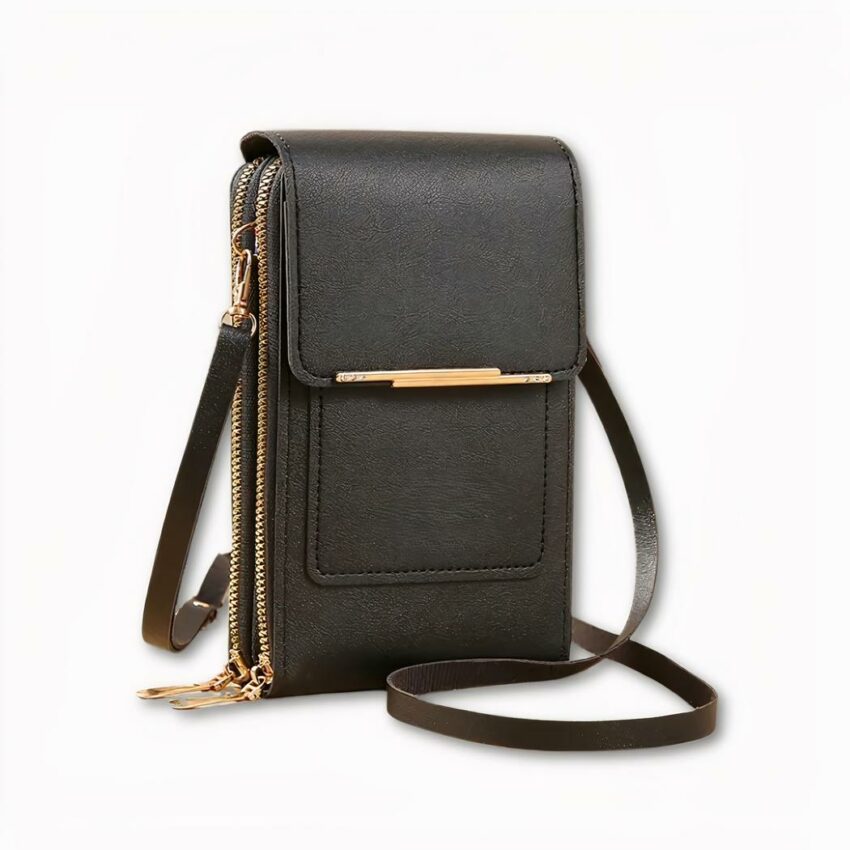 Photo d'une sacoche à bandoulière noire, elle ressemble à un portefeuille. Elle dispose de deux compartiments qui se ferment à fermeture éclair, et d'une pochette avant qui se ferme à rabat et d'un bouton-pression. La sangle est réglable. Le fond de l'image est gris clair.